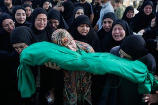 Women grieve as they carry the body of 6-month-old Mariam Fahos during a funeral procession for people killed a day earlier in an Israeli airstrike in the village of Saksakieh, in the southern port city of Sidon, Lebanon, Sunday